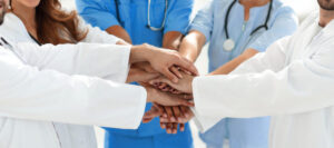 Doctors and nurses stacking hands. concept of mutual aid.