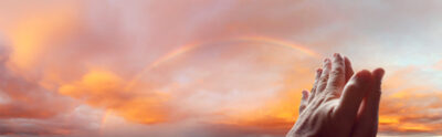 Prayer hands in sky