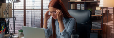 professional woman working through head pain