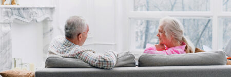 couple on couch discussing hearing loss