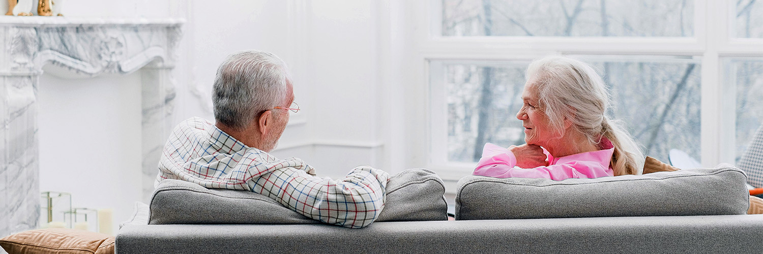 couple on couch discussing hearing loss