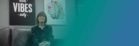 Denise sitting to welcome patients