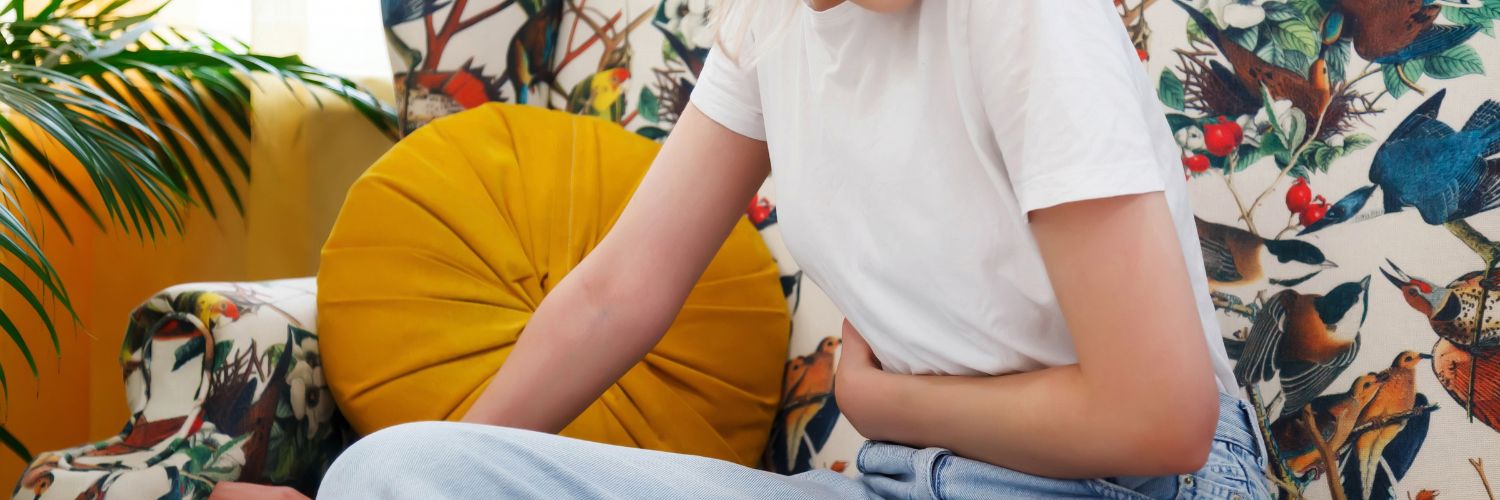 Young Woman with Pain Holding Stomach