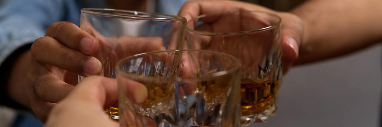 Friends Raising Glasses of Whiskey Together
